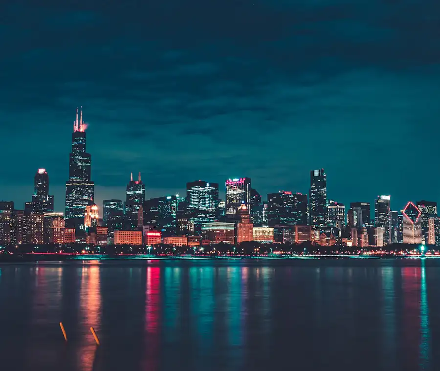 Chicago high-rises lit from within against a deep blue evening sky